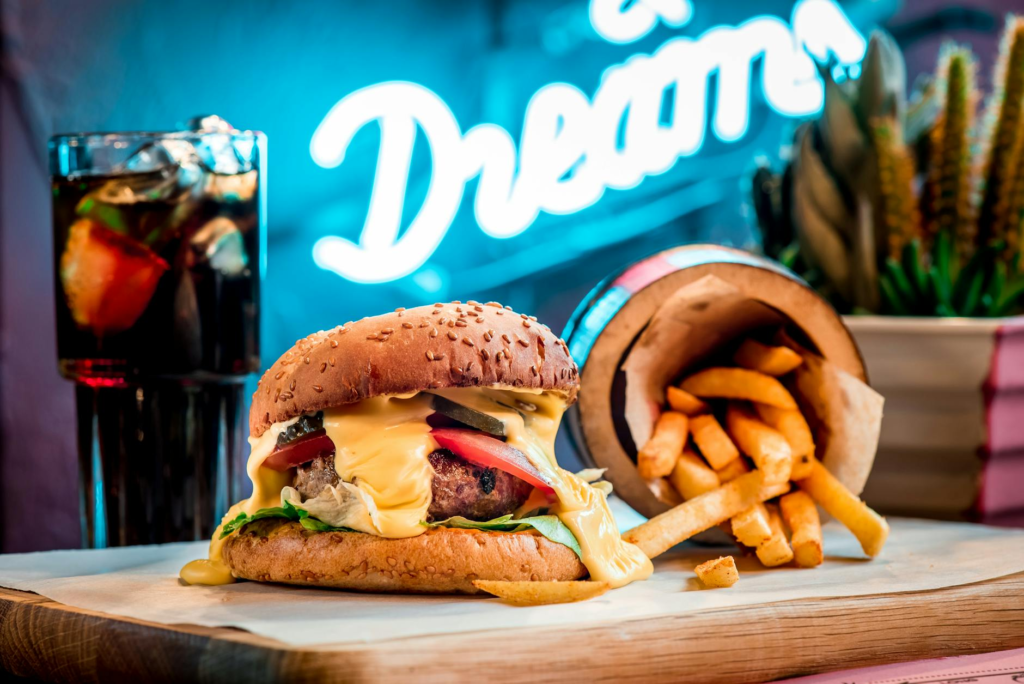 An artistic shot of a gourmet burger with fries, highlighting the vibrant colors and textures. — juiciest burgers Las Ve…