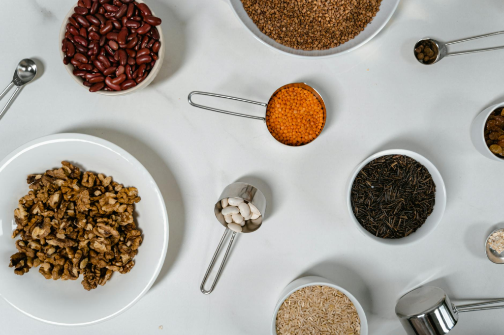 An assortment of ingredients for making homemade vegan burgers, including beans, grains, and spices. — vegan burgers Las…