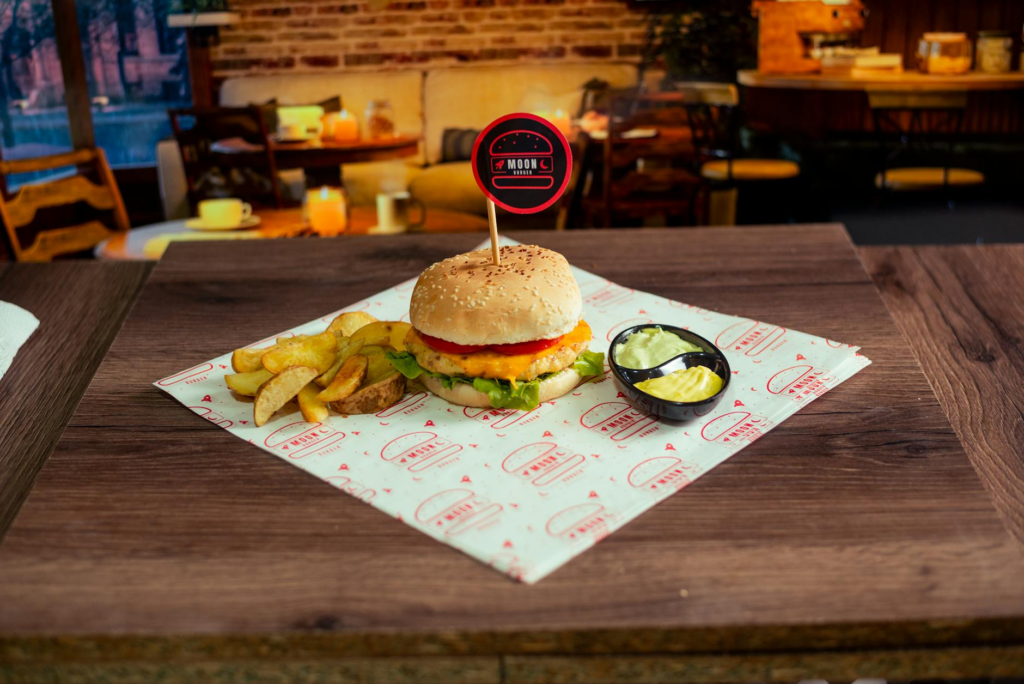 An elegant dining setup featuring a luxury burger with gourmet sides. — gourmet burgers Las Vegas