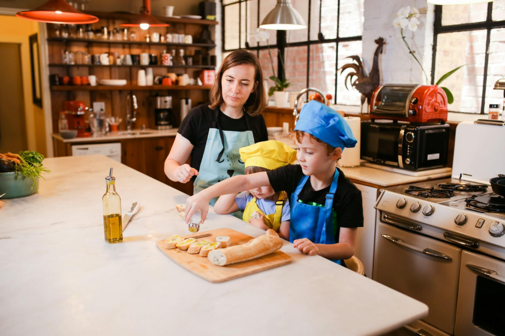 An engaging kitchen scene where kids help prepare cheeseburger sliders for kids.