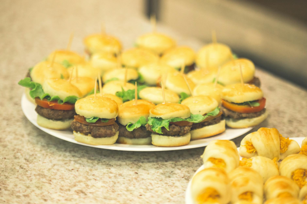 An inviting cocktail prepared with fresh ingredients beside cheeseburger sliders. — drinks to pair with cheeseburger sli…
