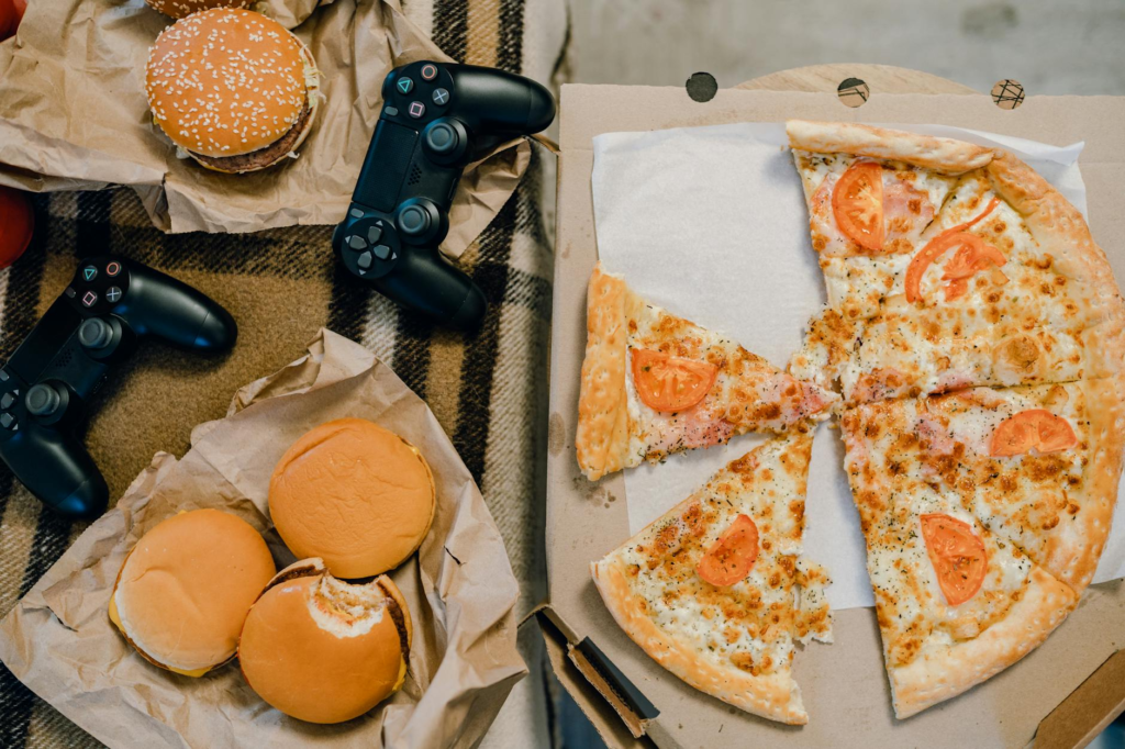 An overhead shot of a game day spread featuring various snacks, including cheeseburger sliders game day