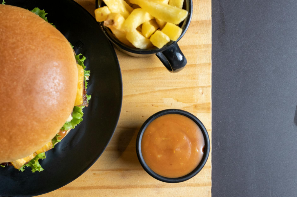 Assorted sauces and toppings ready for burger assembly. — Create Holiday Celebration Burger