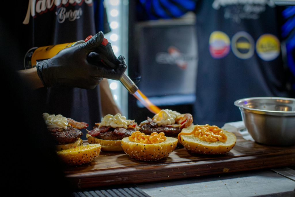 Behind-the-scenes image of chefs preparing burgers in a Las Vegas kitchen. — burger making process Las Vegas