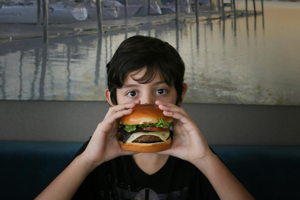 Kids helping to shape the cheeseburger slider patties in a fun kitchen setting. — family cooking cheeseburger sliders