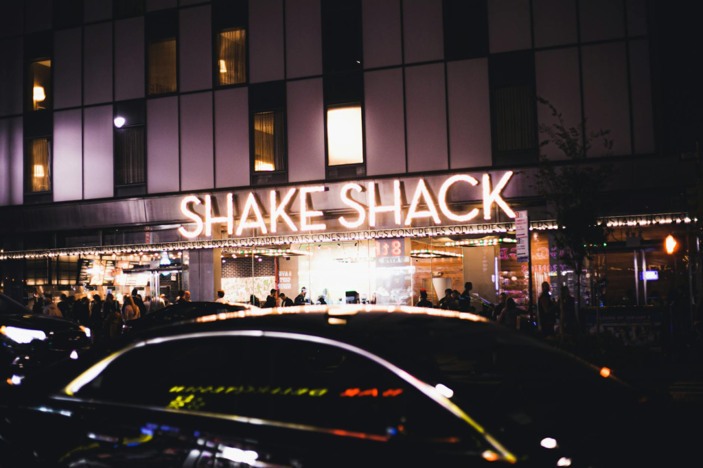 The vibrant atmosphere of Shake Shack with people enjoying their gourmet burgers. — gourmet burgers Las Vegas