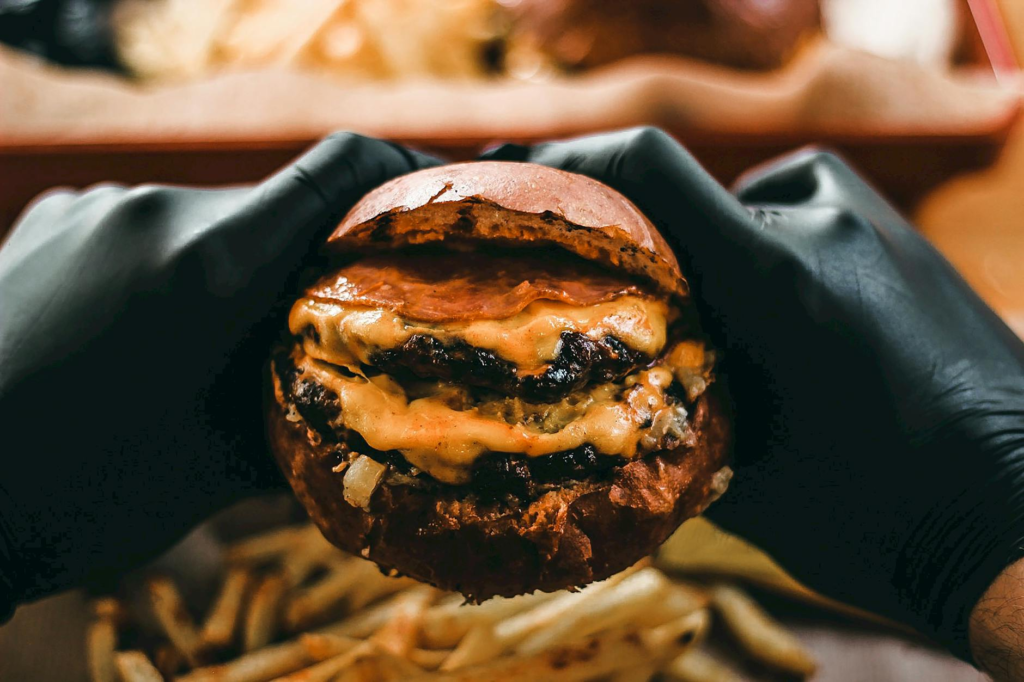 a mouth-watering close-up of a classic cheeseburger with fries — budget burgers Las Vegas