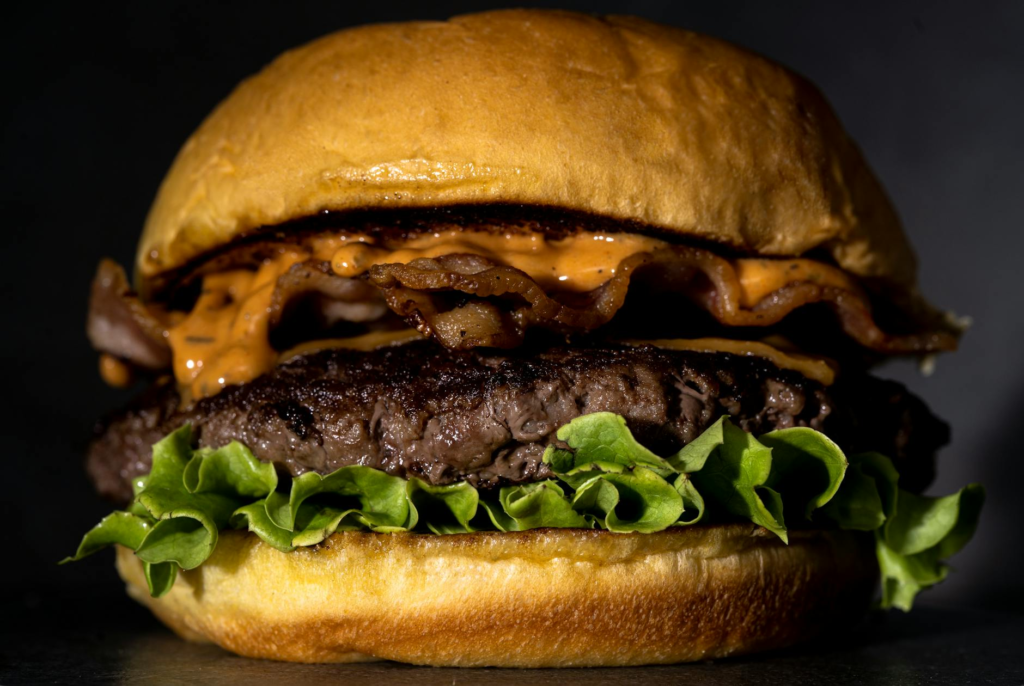 A close-up of an affordable burger from a local Las Vegas joint, emphasizing quality and value. — burger deals Las Vegas
