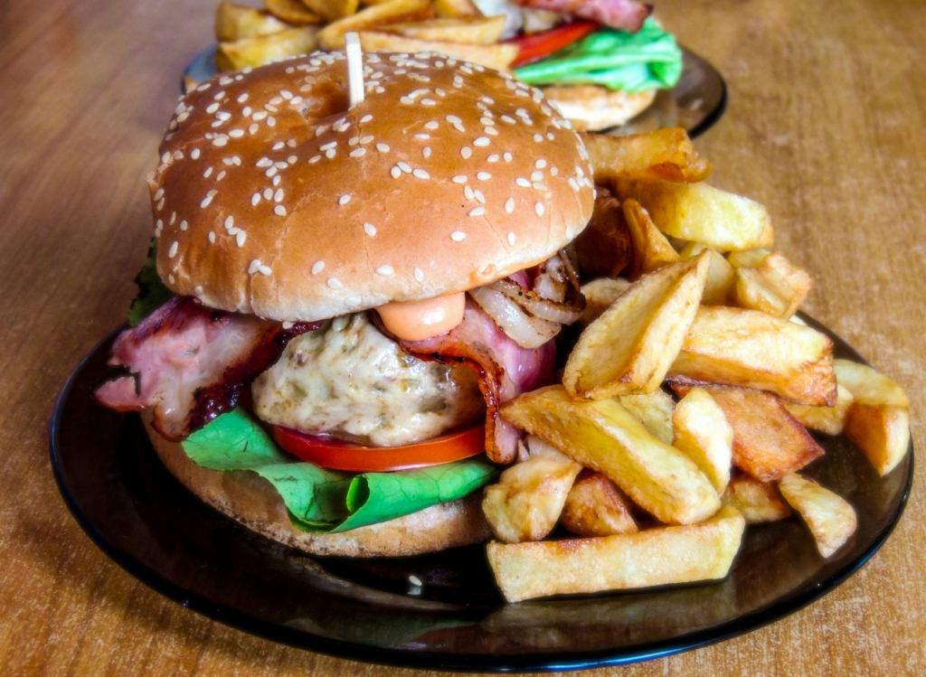 A close-up shot of a juicy burger with fries, perfect for extreme eating. — burger challenges Las Vegas