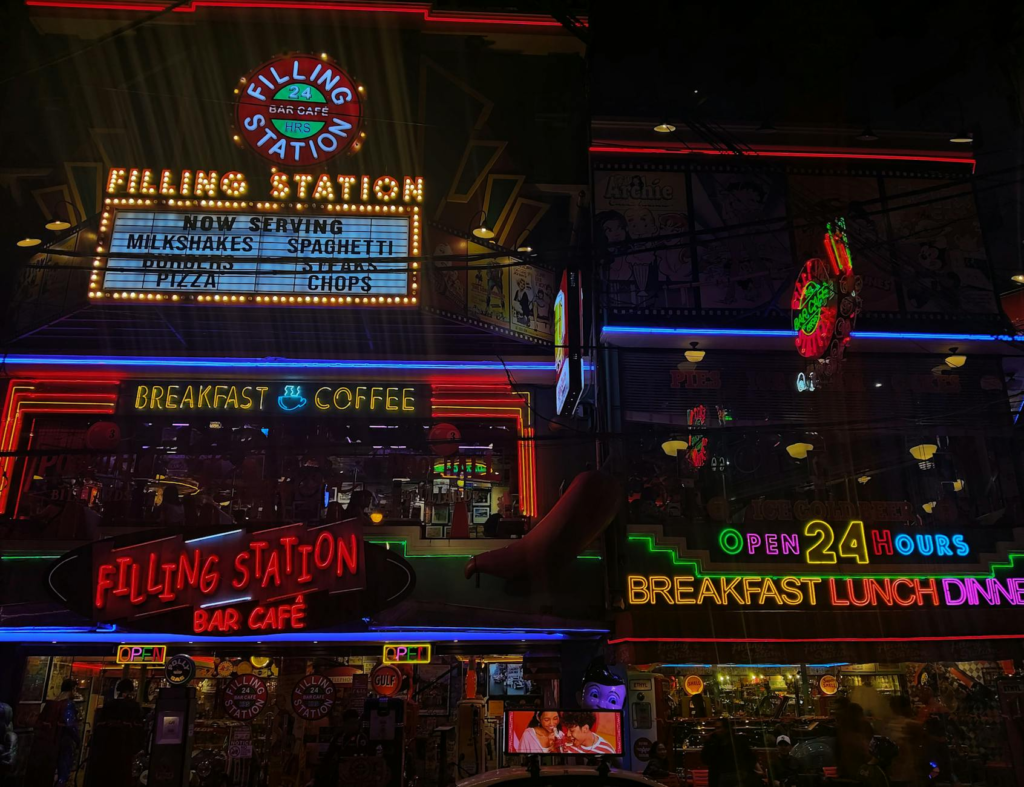 A vibrant nightlife scene in Las Vegas with illuminated signs for 24-hour burger restaurants. — late night burgers Las V…