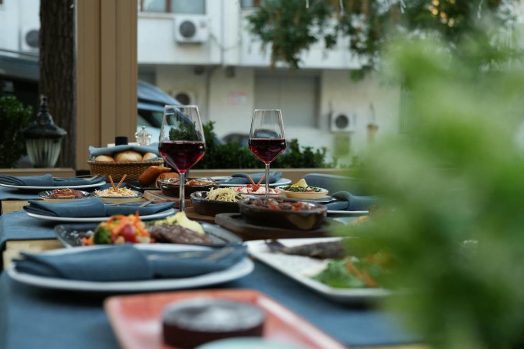 An elegant dining setting featuring a gourmet burger and fine wine, perfect for a luxury dining experience. — gourmet bu…