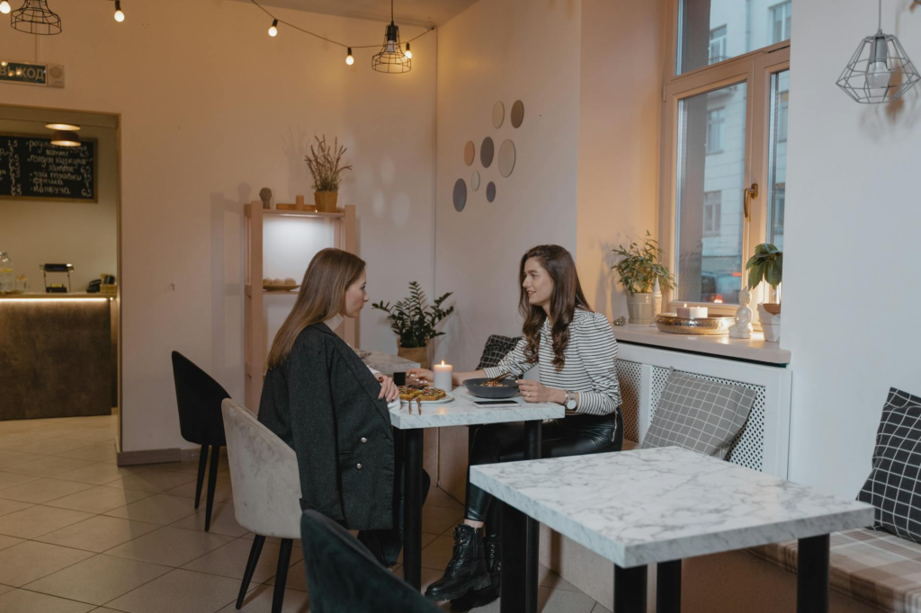 An interior shot of a trendy vegan restaurant with diners enjoying their meals while savoring the best vegan burgers Las Vegas has to offer.