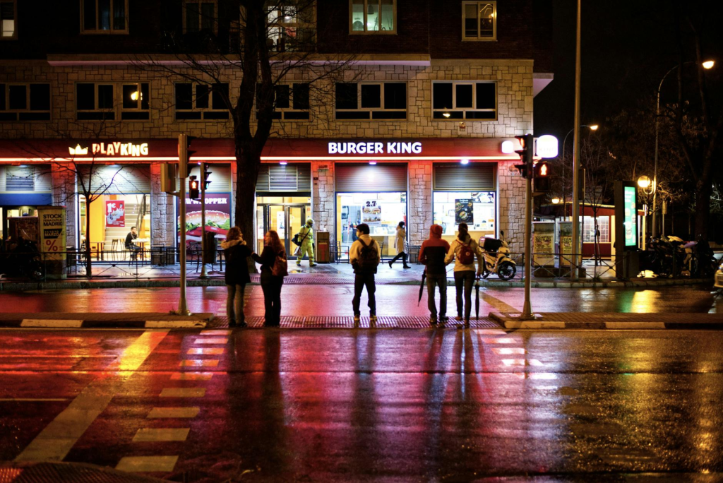 An outdoor view of a famous burger spot with people waiting in line at night. — late night burgers Las Vegas