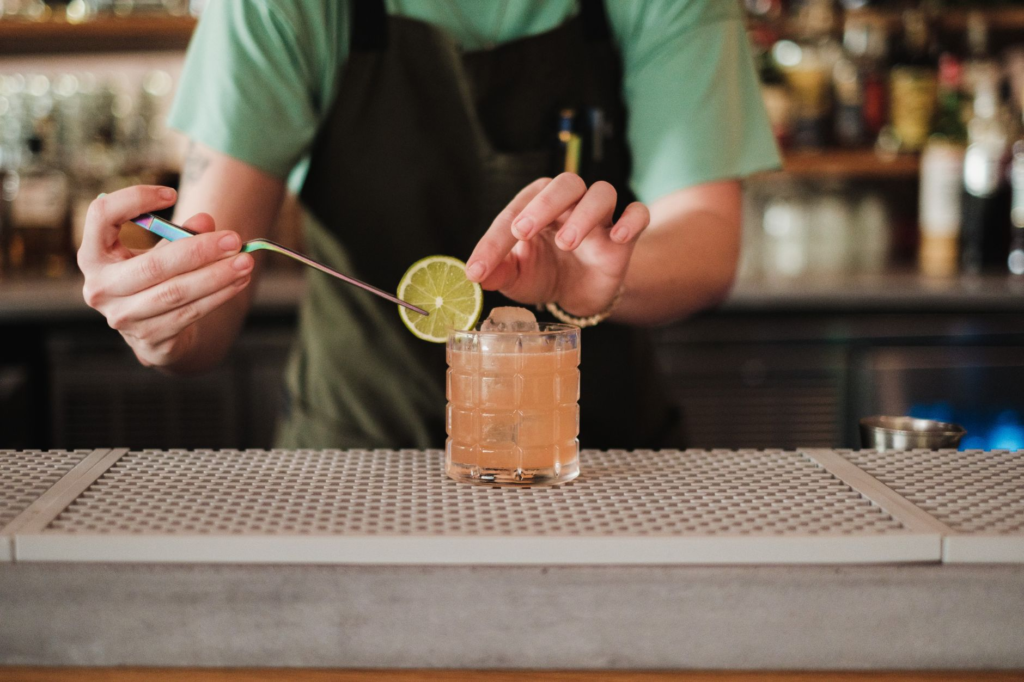 A bartender preparing a refreshing cocktail to pair with a burger. — juiciest burgers Las Vegas Strip
