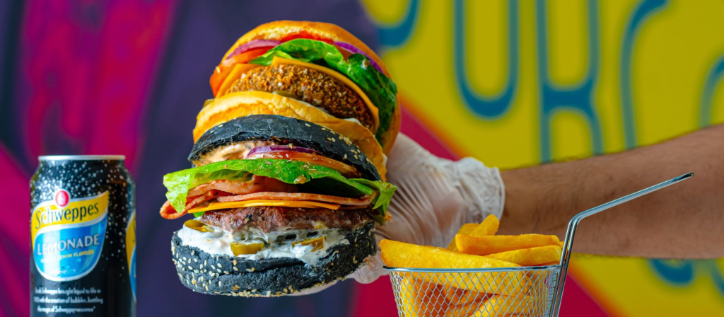 A beautifully arranged Rainbow Burger with layers of colorful ingredients. — Instagrammable burgers Las Vegas
