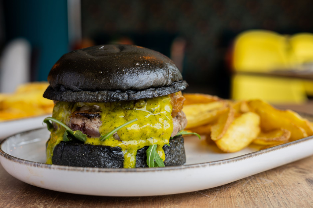 A beautifully plated burger from The Black Sheep, featuring unique and colorful ingredients. — iconic burgers Las Vegas