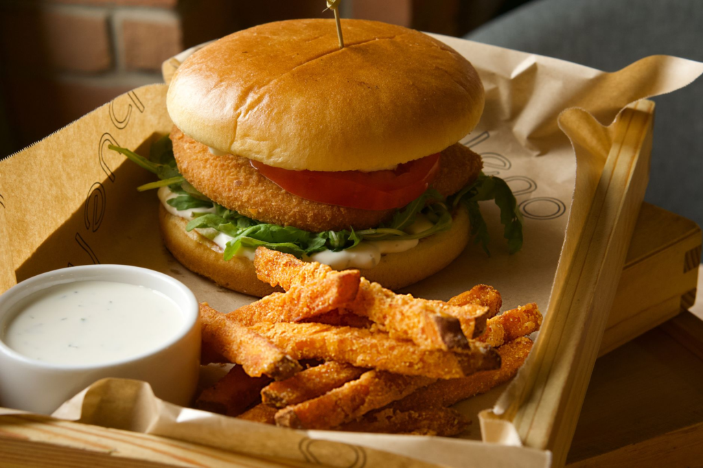 A beautifully plated gourmet burger with fresh ingredients and a side of sweet potato fries. — gourmet burgers Las Vegas