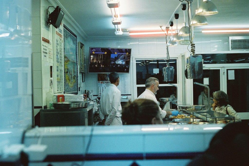 A chef preparing a burger in a bustling kitchen at a late night eatery. — late night burgers Las Vegas