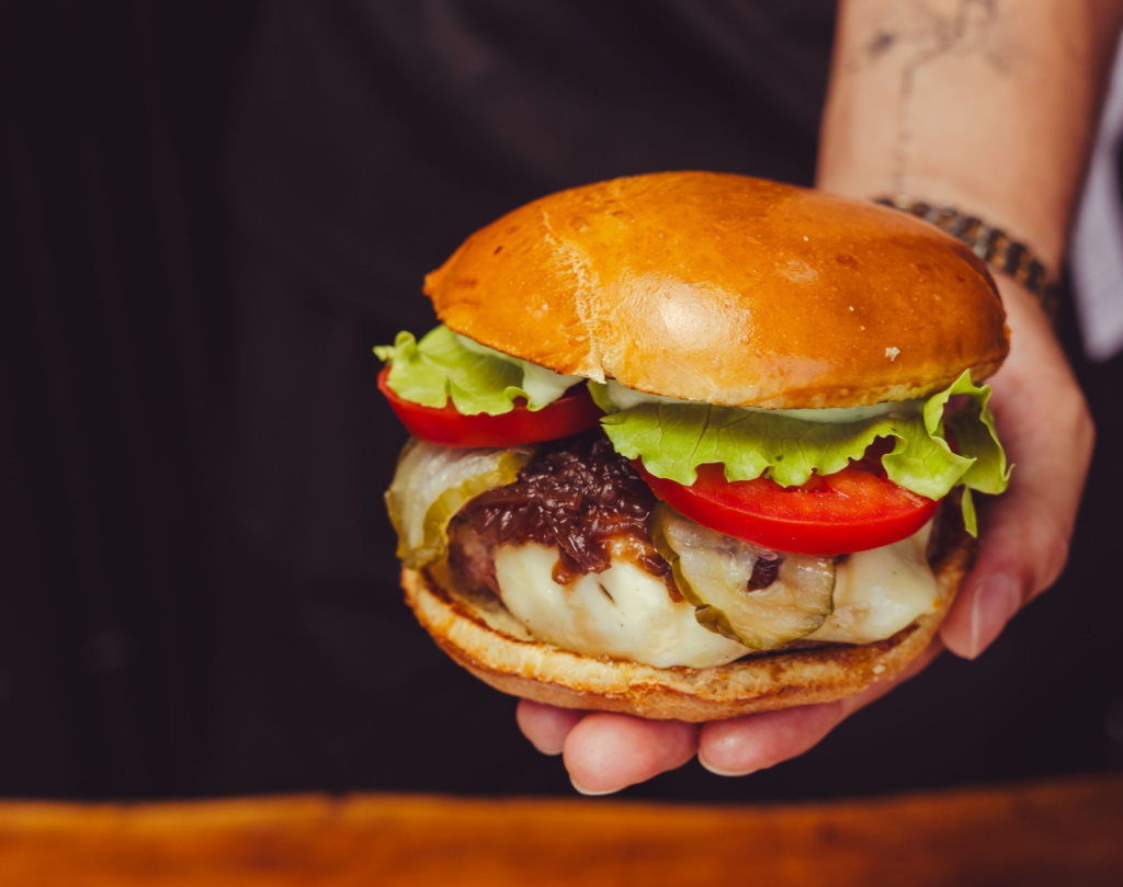 A close-up of a gourmet burger showcasing its toppings and ingredients. — burgers and beer Las Vegas
