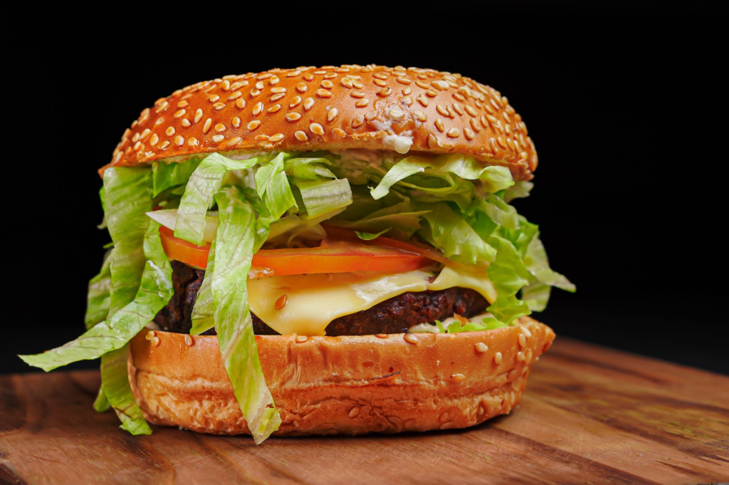 A close-up of a juicy burger with fresh toppings, highlighting the quality of affordable burgers Las Vegas options.
