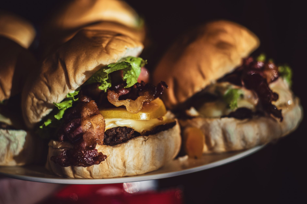 A close-up of a juicy burger with melted cheese and crispy bacon, highlighting its deliciousness. — burgers near Las Veg…