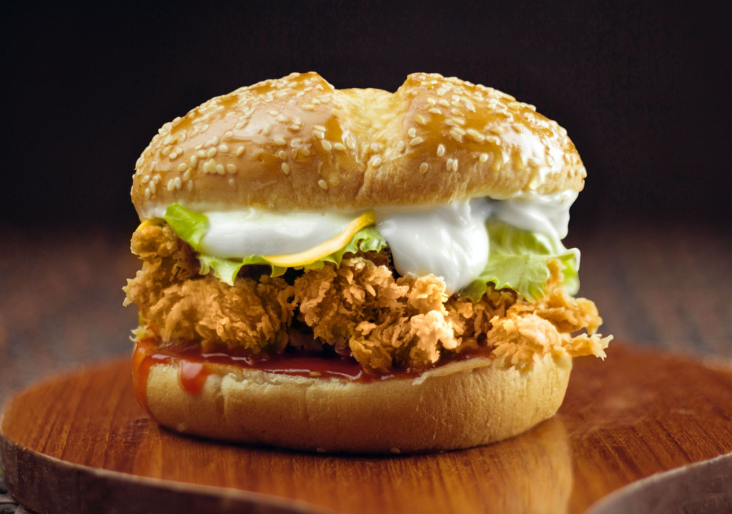 A close-up of a spicy burger dripping with sauce, emphasizing its heat and flavor. — spicy burgers Las Vegas
