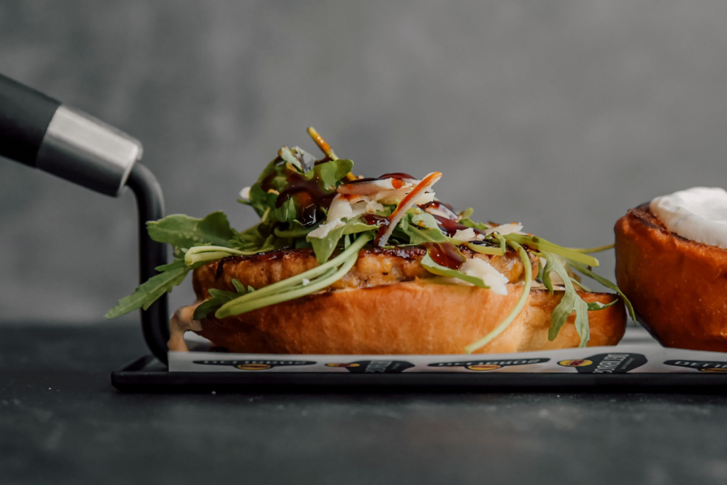 A close-up of a vegetarian burger with fresh ingredients and side salads — late-night burgers Las Vegas