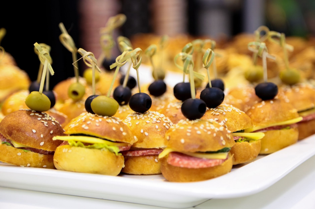 A colorful display of different burgers available for tasting at a festival. — burger festivals Las Vegas
