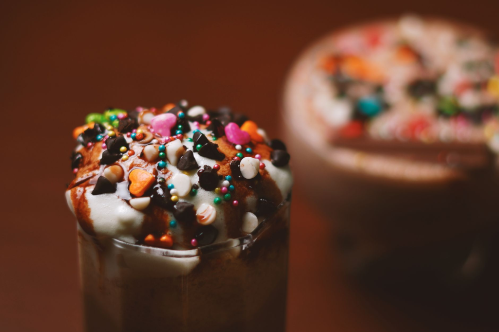 A colorful milkshake from Holsteins Shakes and Buns adorned with whipped cream and sprinkles. — burger and shake las vegas