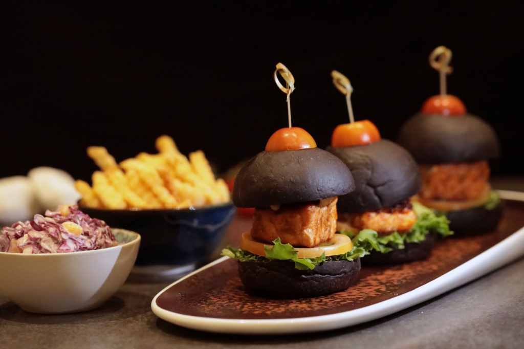 A colorful plate of vegetarian burgers served with unique toppings and sides. — burgers near Las Vegas Strip