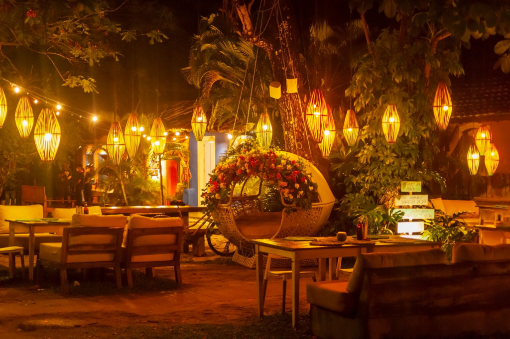 A cozy outdoor seating arrangement with string lights and comfortable seating at a Las Vegas burger restaurant. — burger…
