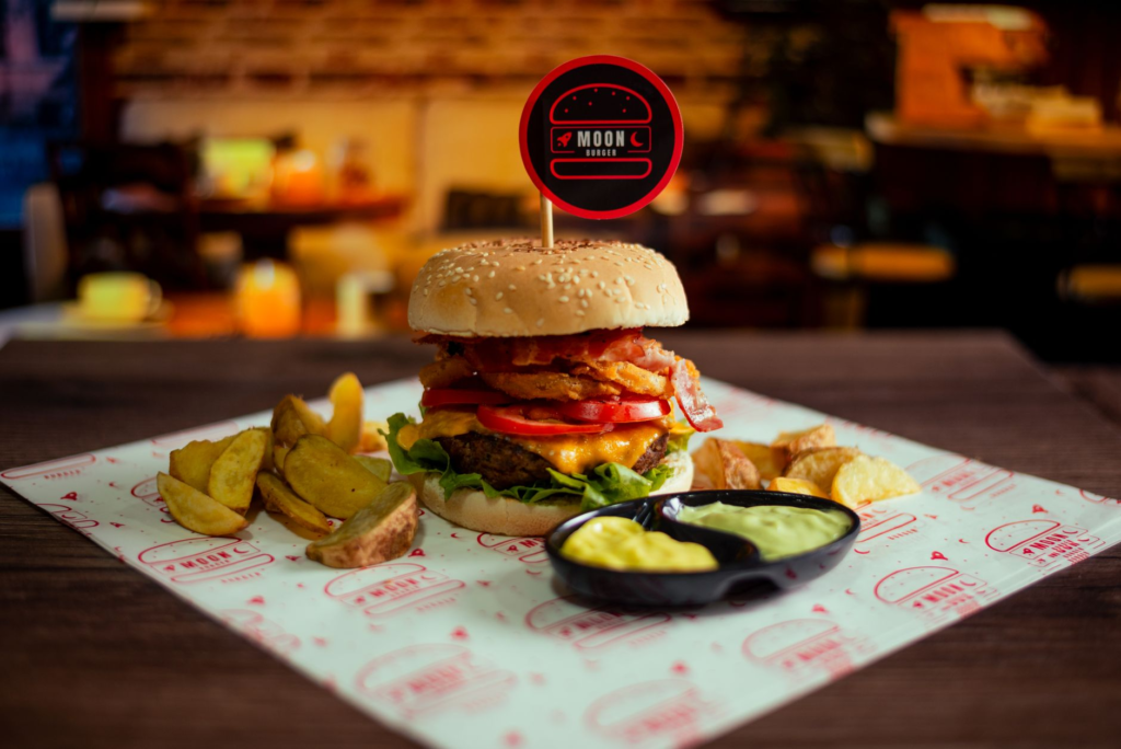 A delicious Fatburger with fries on a table, emphasizing the late-night dining experience. — late night burgers Las Vegas