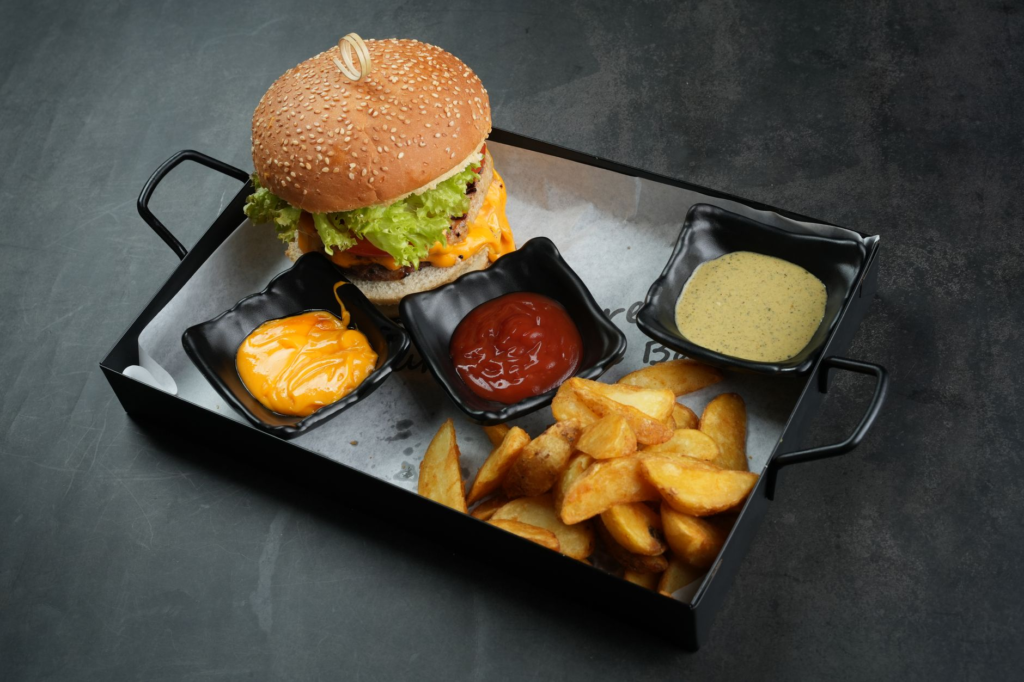 A delicious Fatburger with toppings galore, highlighting its signature size and flavor. — burger chains Las Vegas