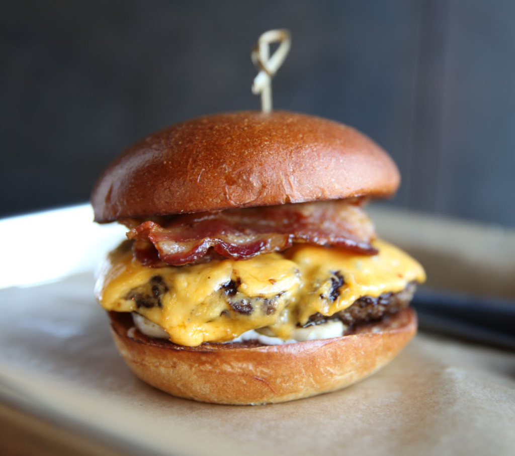 A delicious, juicy burger with melted cheese and fresh toppings at a popular Las Vegas Strip diner. — burgers near Las V…