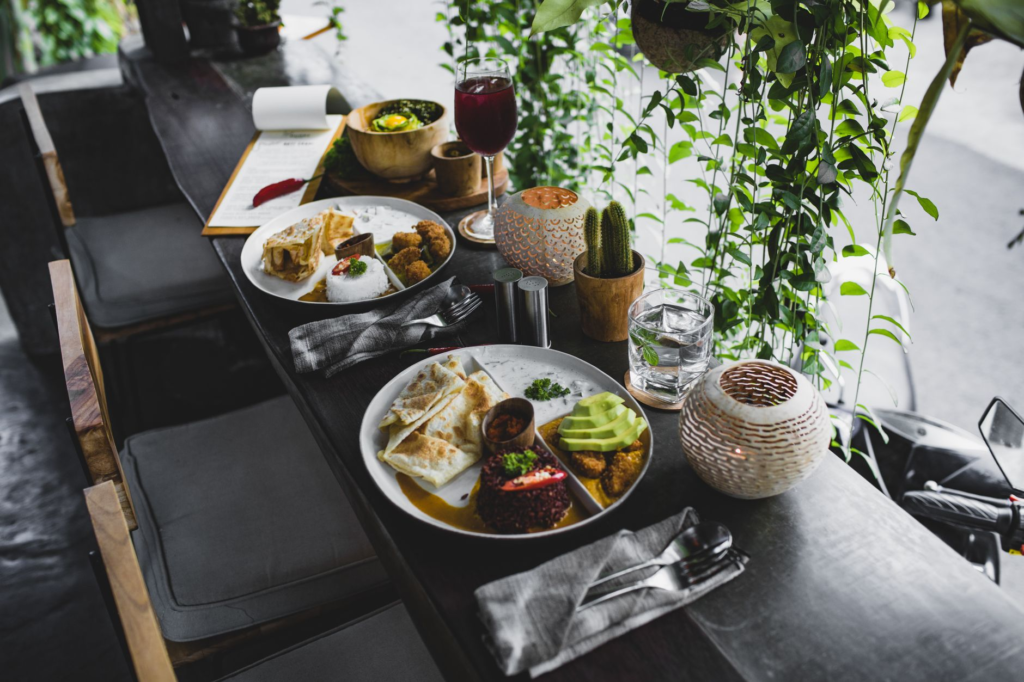 A group of friends enjoying various plant-based meals at a Las Vegas eatery. — plant-based burgers Las Vegas