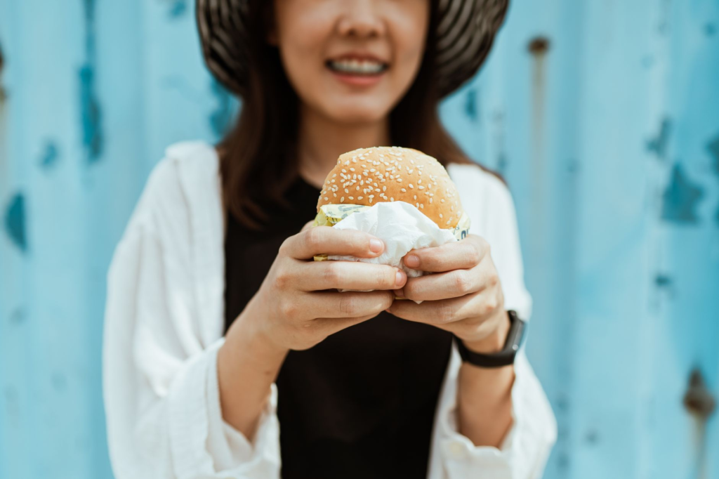 A happy customer enjoying a vegan burger in Las Vegas — vegan burgers Las Vegas
