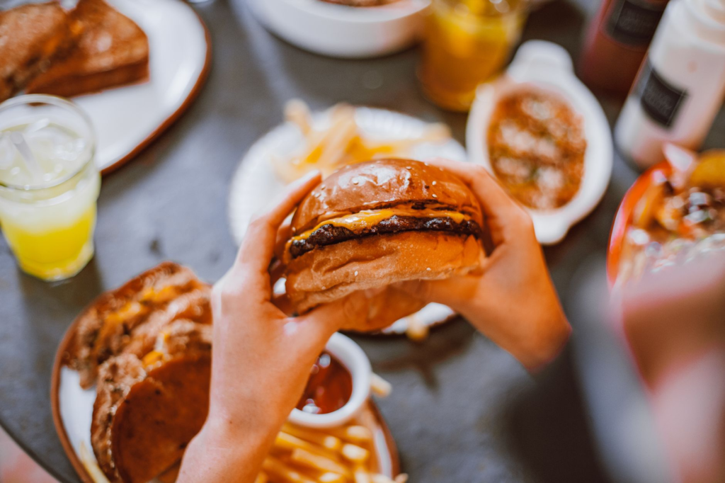 A happy customer enjoying a vegan burger with fries at a popular restaurant. — vegan burgers in Las Vegas