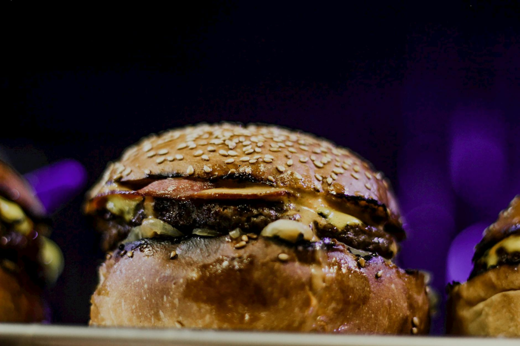 A juicy late night burger with melted cheese and fresh toppings — late night burgers Las Vegas