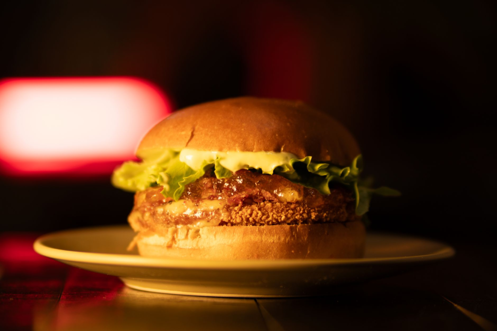 A luxurious Edible Gold Burger, glimmering under perfect lighting. — Instagrammable burgers Las Vegas