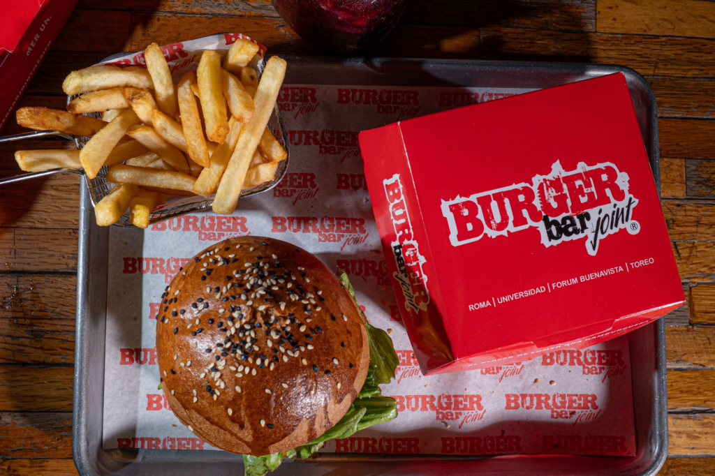 A mouth-watering burger from The Burger Bar with fries — hidden burger gems Las Vegas