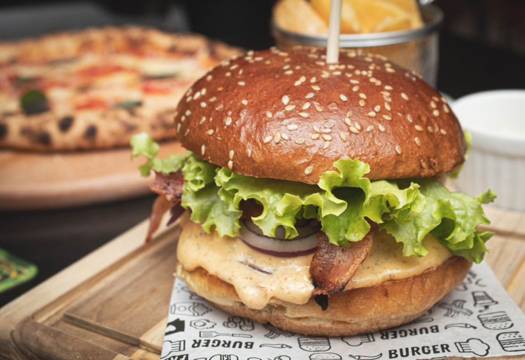 A mouth-watering burger with fresh toppings and fries from a popular restaurant near Allegiant Stadium. — burgers near a…