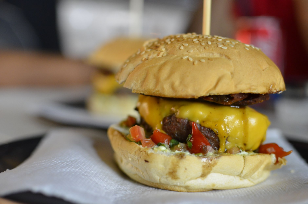 A mouth-watering close-up of a classic cheeseburger with fresh toppings at a popular Las Vegas burger joint. — cheap bur…