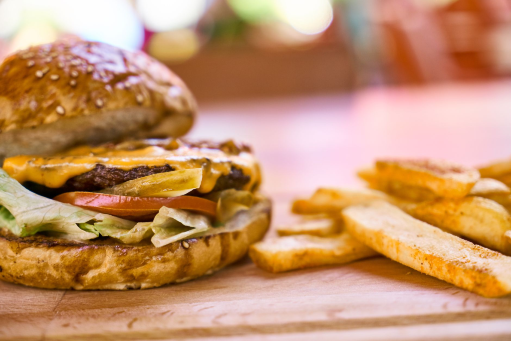 A mouth-watering close-up of a classic cheeseburger with fries at a popular Las Vegas restaurant. — burger deals Las Vegas