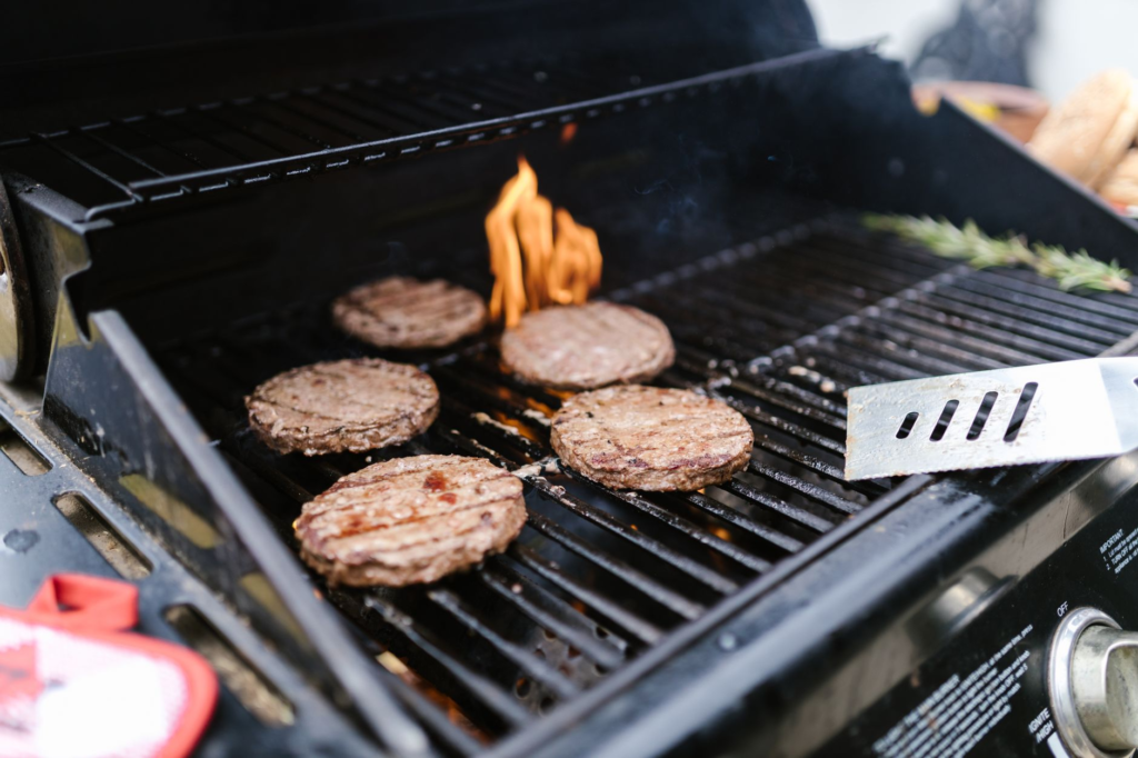 A mouth-watering image of a smash burger being prepared on the grill, with juices sizzling. — smash burgers las vegas