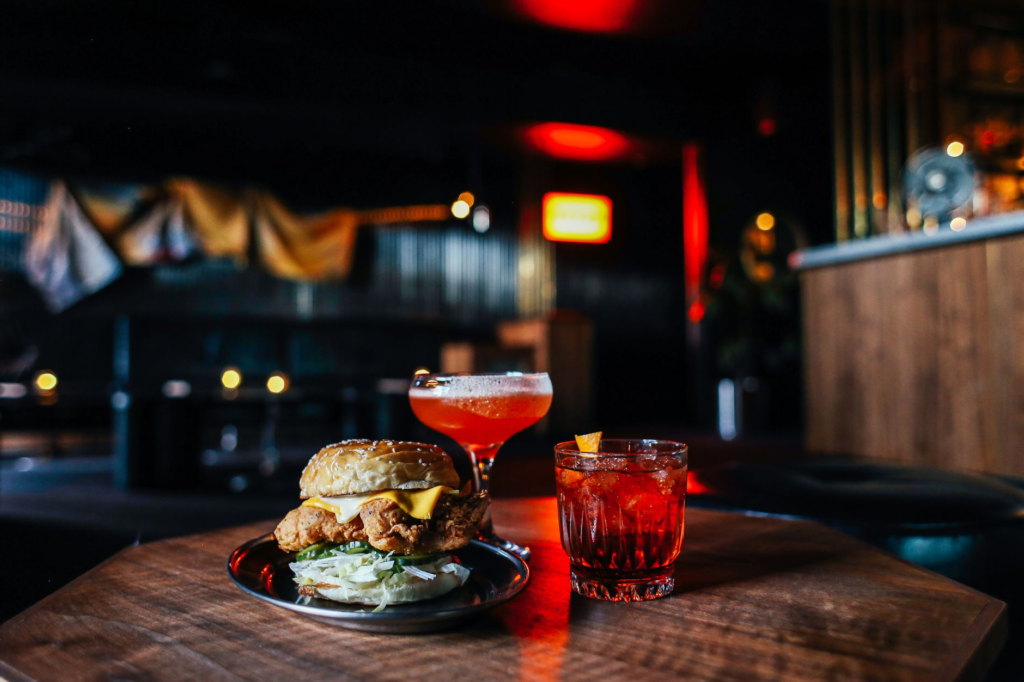 A mouth-watering late-night burger with fries on a dimly lit restaurant table — late-night burgers Las Vegas