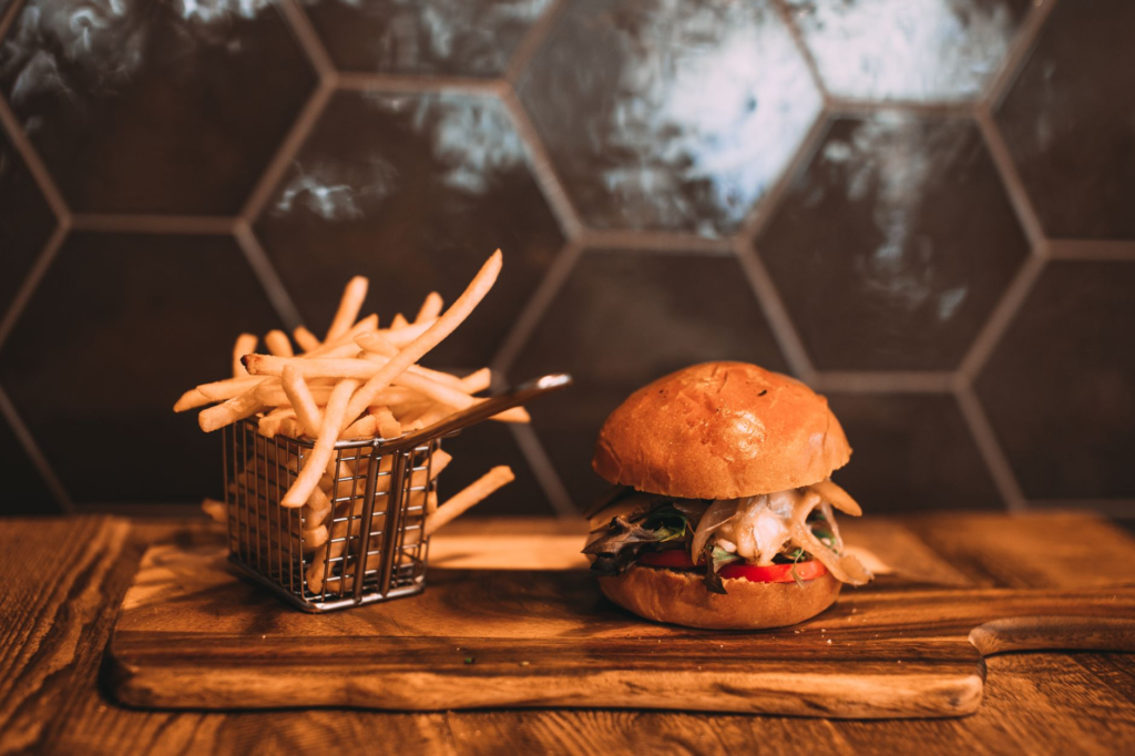 A mouthwatering burger with fries on a restaurant table in Las Vegas — burger deals Las Vegas