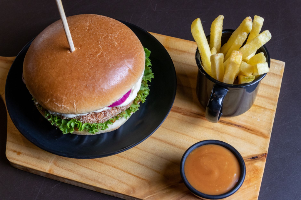 A mouthwatering gourmet burger with fresh toppings and a side of fries. — gourmet burgers in Las Vegas