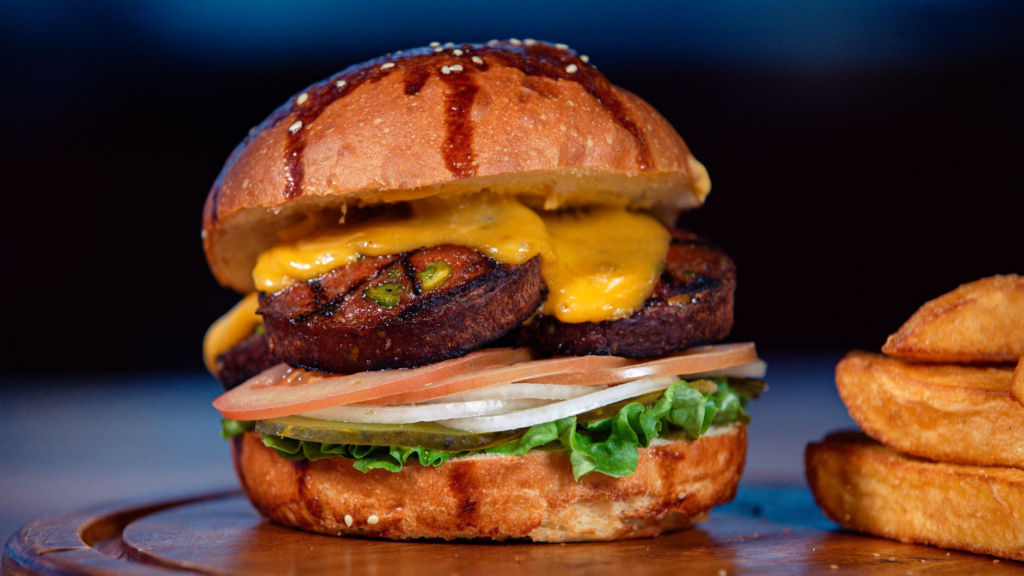 A mouthwatering vegan burger with fresh toppings and a side of sweet potato fries — vegan burgers Las Vegas