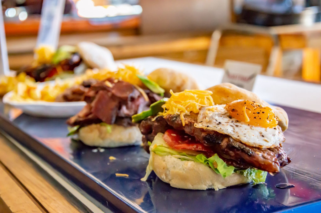 A platter of various breakfast burgers, highlighting different toppings and styles available in Las Vegas. — breakfast b…
