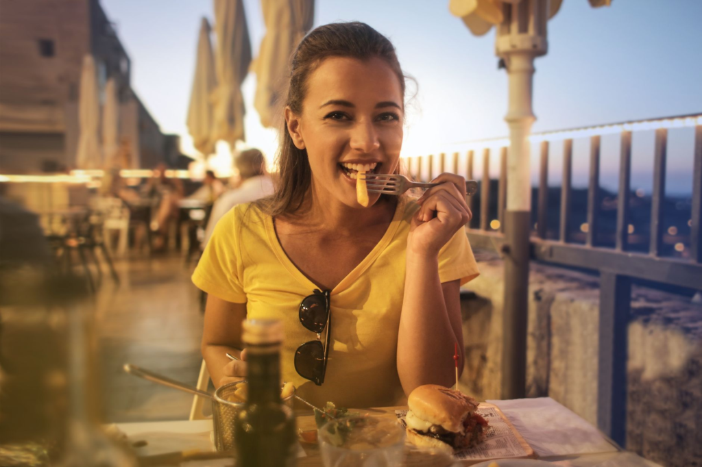A vibrant happy hour scene showcasing burgers and drinks at sunset — burger deals Las Vegas